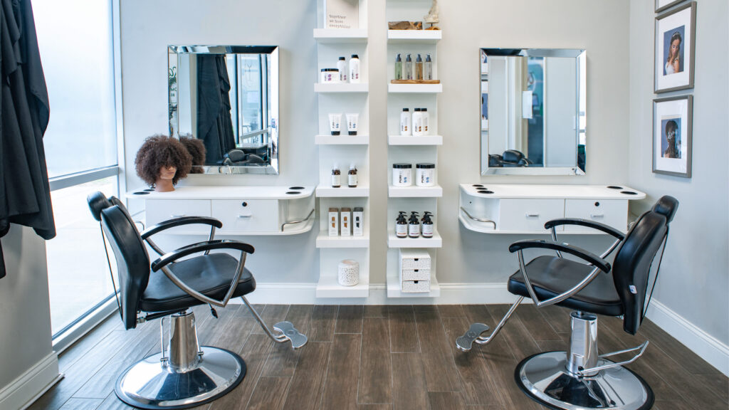 Modern hair salon with styling chairs and products.