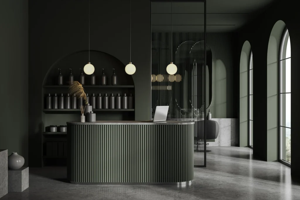 Modern reception desk with dark decor and lighting.